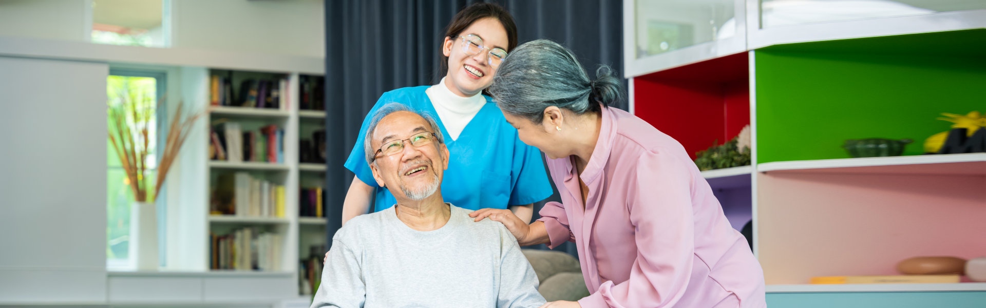 Caring Home Nurse Visits Senior Man In Wheelchair