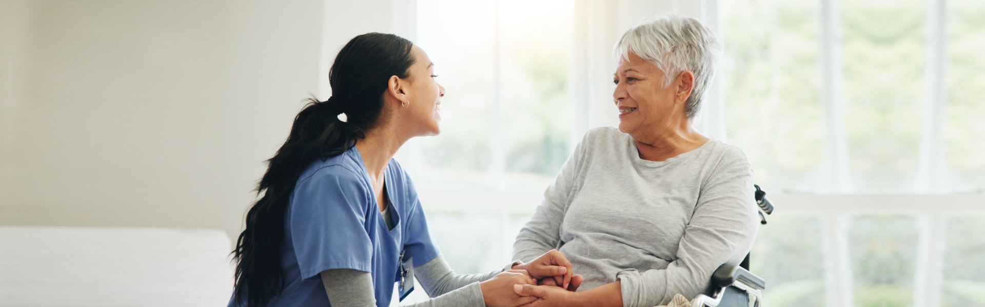 Woman Holding Hands with Senior Woman